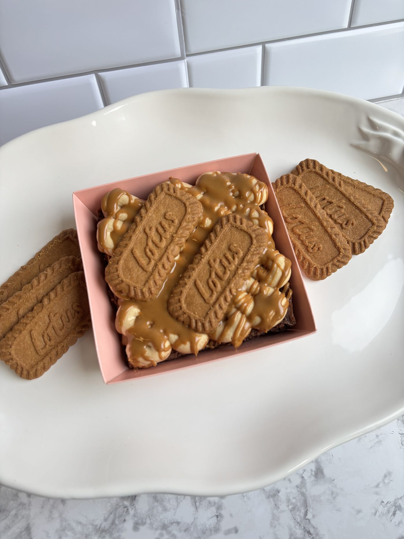 Brownies topped with Biscoff cookies and caramel drizzle