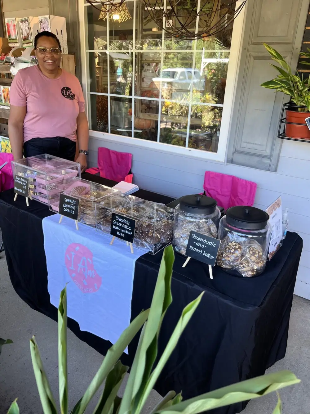 I Am Cookie and Sugar Co. booth with customers browsing treats