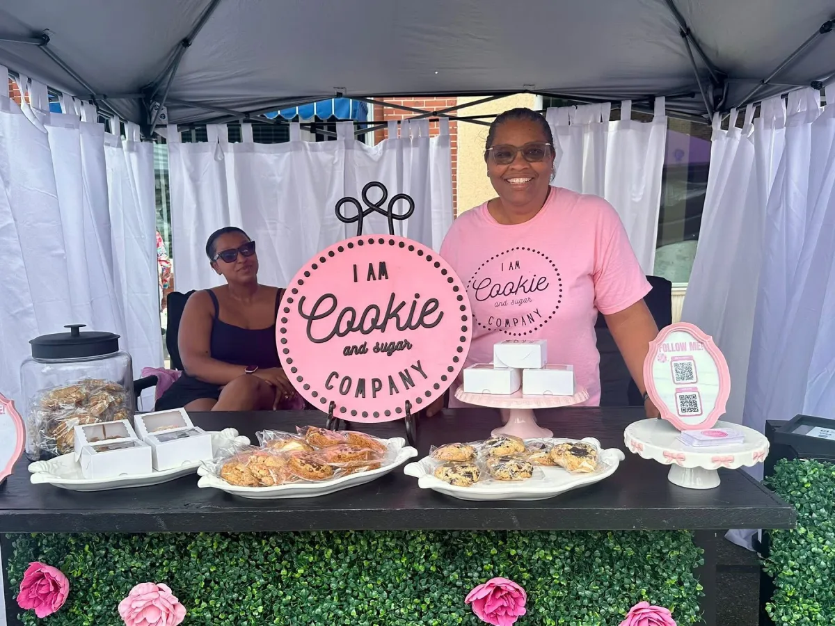 I Am Cookie and Sugar Co. vendor booth beneath a market tent
